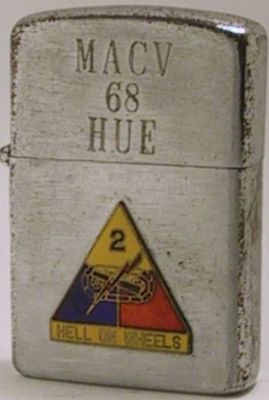 This is a Universe Lighter with the engravings "MACV 68 Hue".&nbsp; The Military Assistance Command Vietnam had quarters in Hue.&nbsp; The attached badge is that of the 2nd Armored Division of the Army nicknamed Hell on Wheels